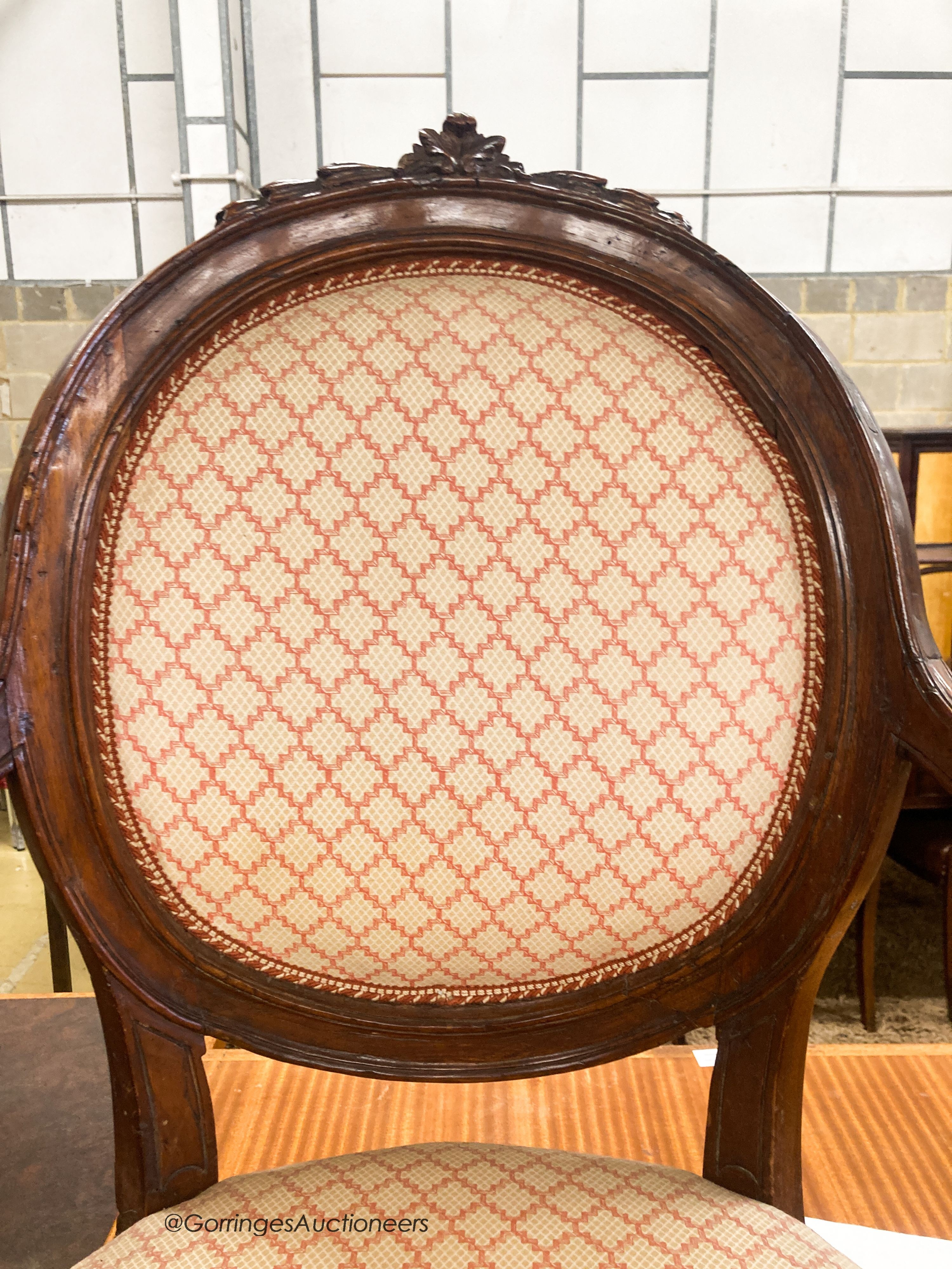 A pair of 19th century French walnut upholstered elbow chairs, W.62cm D.50cm H.102cm